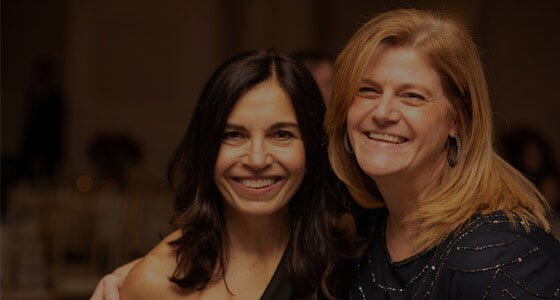 two women smiling at the camera