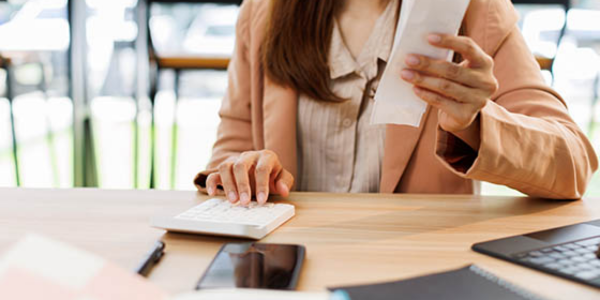 woman using calculator to create accountable plan