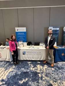harlene stevens and jake forestiere in front of nisivoccia exhibition at njda annual convention 