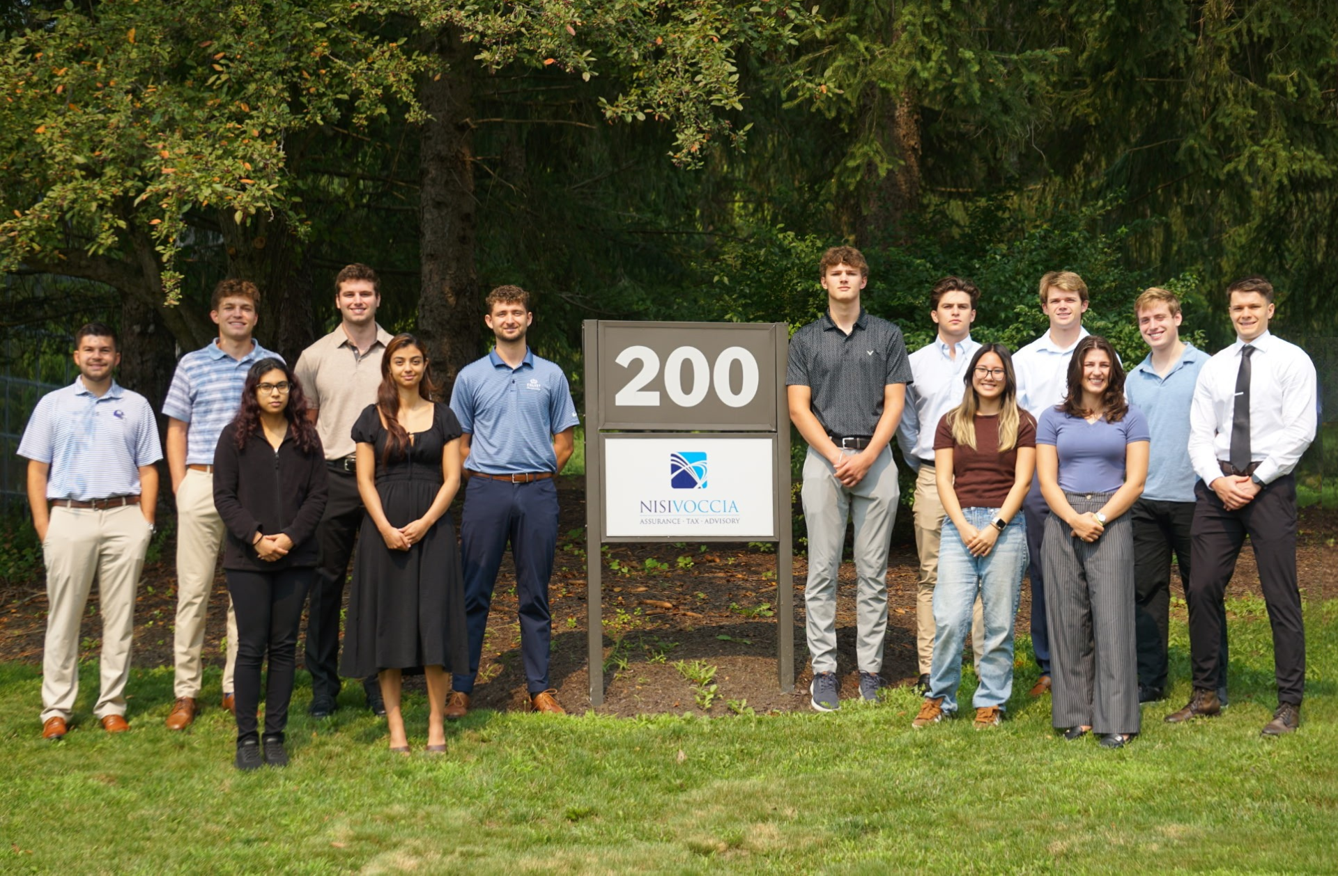 2026 interns standing around Nisivoccia sign