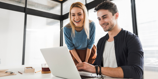 two people at work at laptop discussing protected-leave