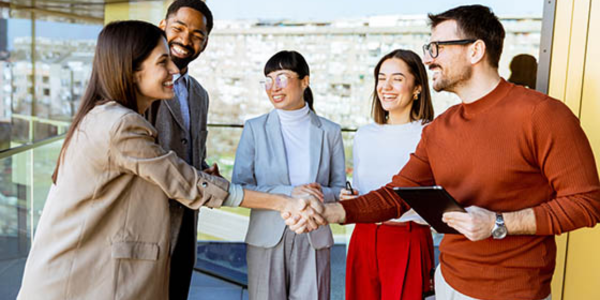 business people in a group shaking hands