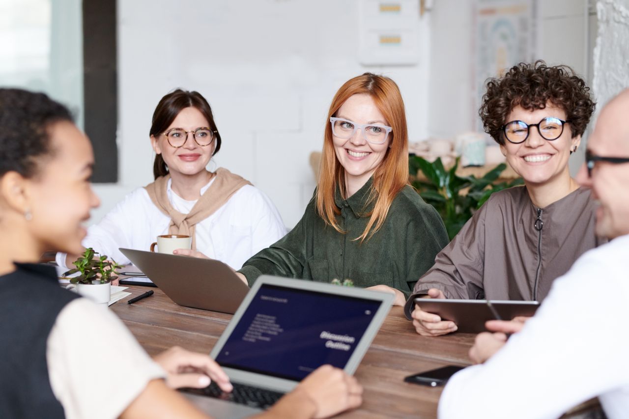 A diverse group of professionals collaborating in an office environment, focusing on teamwork and innovation.