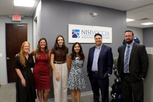 Nisivoccia team in front of sign in Bridgewater office