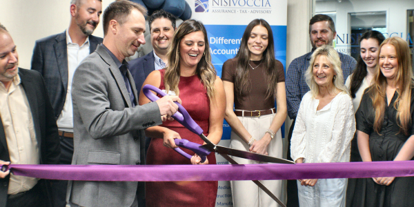 Kristin Anderson and Chris Perrotta cutting ribbon at ceremony