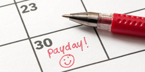 calendar showing payday with a smiley face
