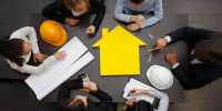 construction contractors and builders meeting at a table with materials on table