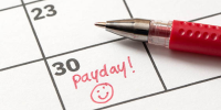 calendar showing payday with a smiley face